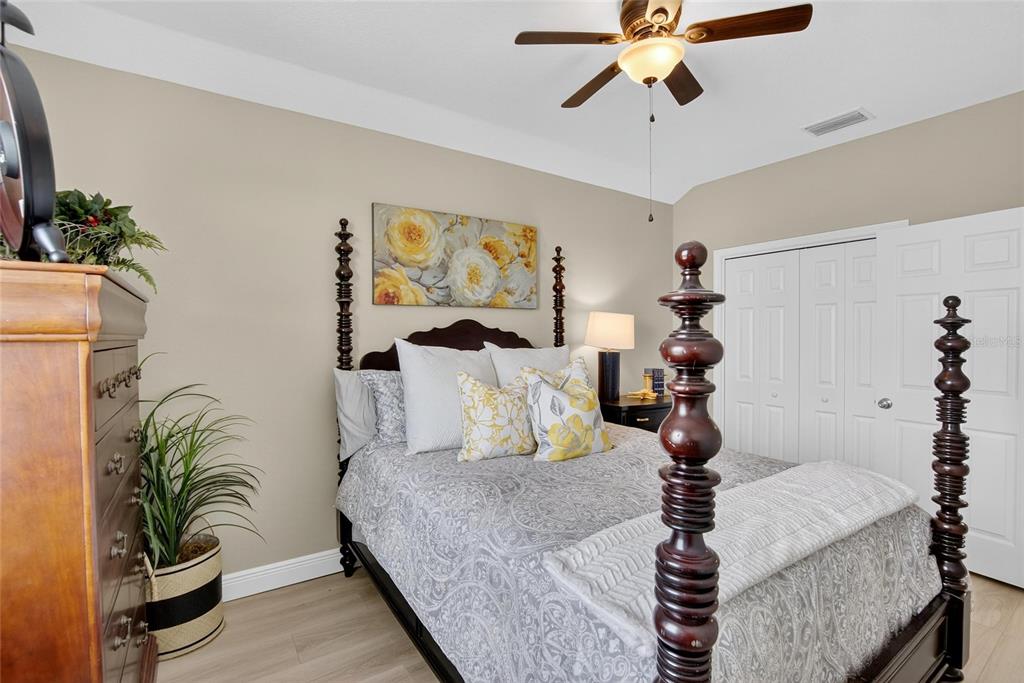 306 Hope Bay Loop Apollo Beach, FL 33572 - Photo 36 of 53 a bed room with a bed and a chandelier