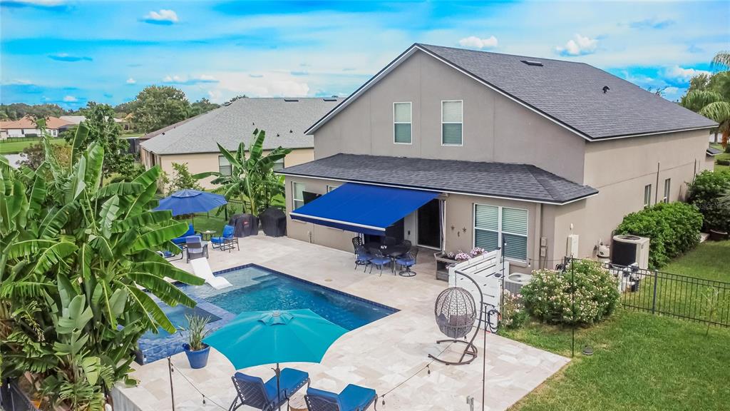 306 Hope Bay Loop Apollo Beach, FL 33572 - Photo 37 of 53 a backyard of a house with table and chairs