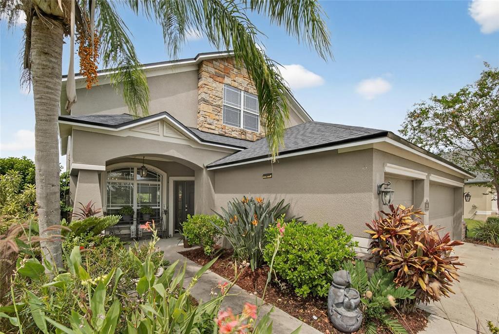 306 Hope Bay Loop Apollo Beach, FL 33572 - Photo 4 of 53 a front view of a house with a yard