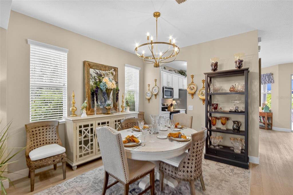 306 Hope Bay Loop Apollo Beach, FL 33572 - Photo 9 of 53 a view of a dining room with furniture wooden floor and a chandelier