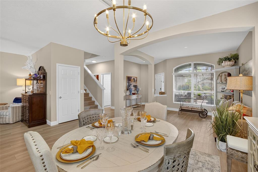 306 Hope Bay Loop Apollo Beach, FL 33572 - Photo 10 of 53 a view of a dining room with furniture a chandelier and wooden floor