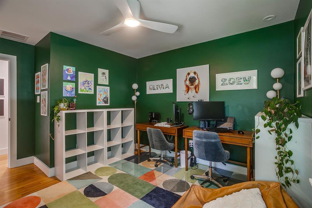 6700 Fortune Road Fort Worth, TX 76116 - Photo 32 of 40 Room featuring rich green walls, a ceiling fan with integrated lighting, and wood-finish flooring