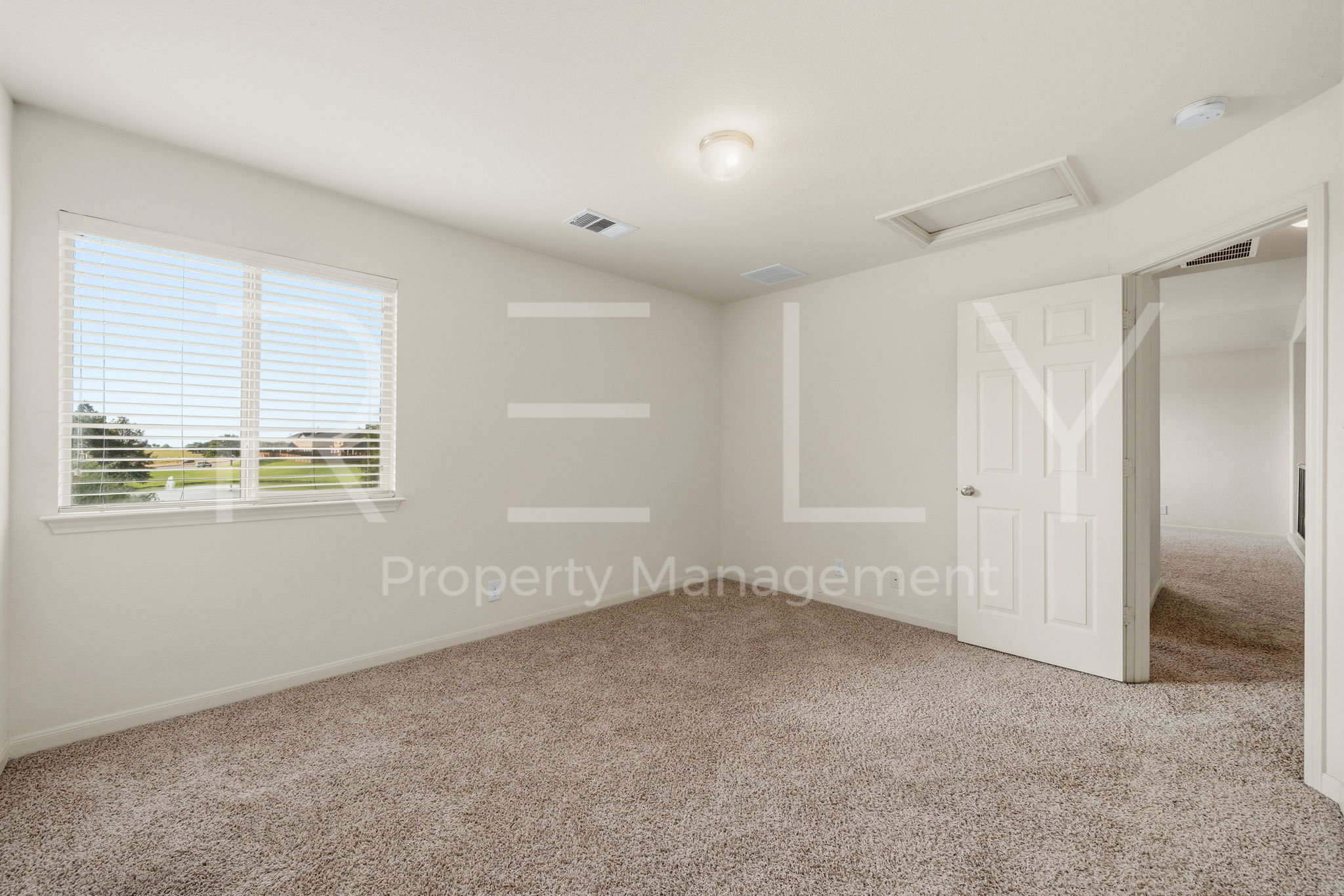 1405 Sunny Meadows Loop Georgetown, TX 78626 - Photo 29 of 40 A well-proportioned bedroom offers soft carpeting and a window with venetian blinds.