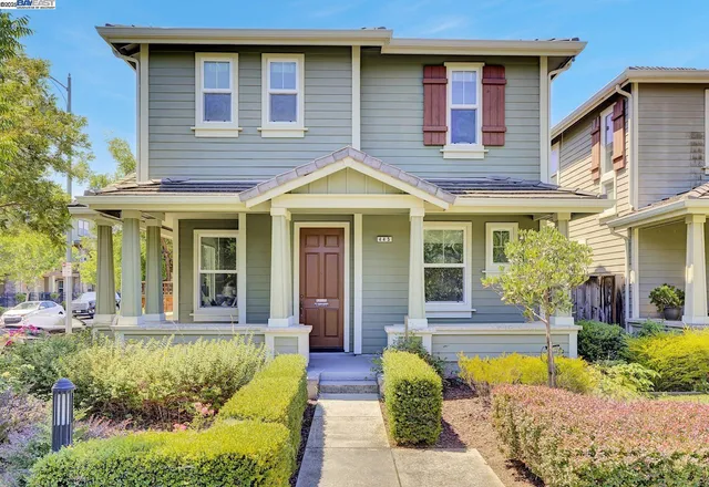 a front view of a house with swimming pool and porch