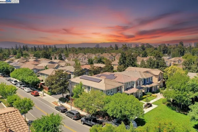 an aerial view of residential houses with outdoor space and street view