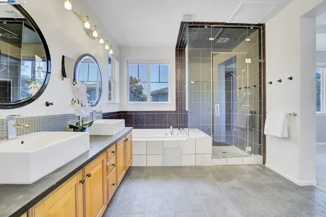 a bathroom with a double vanity sink and a mirror