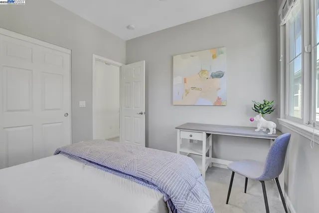 a bedroom with a bed and a table in it