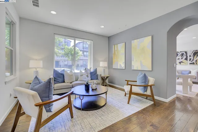 a living room with furniture and a potted plant