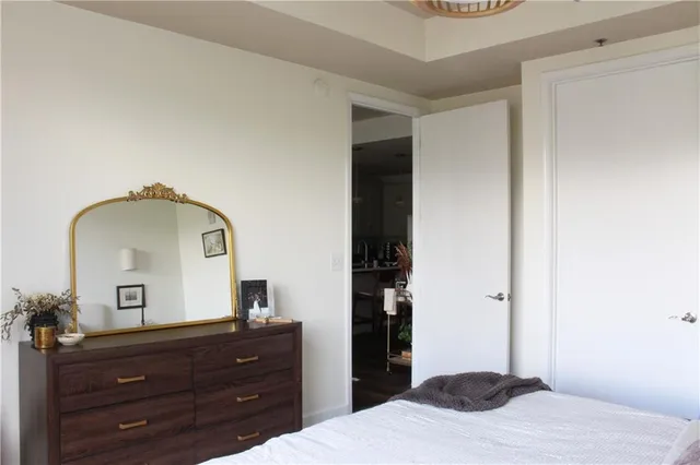 a bedroom with a bed and a dresser