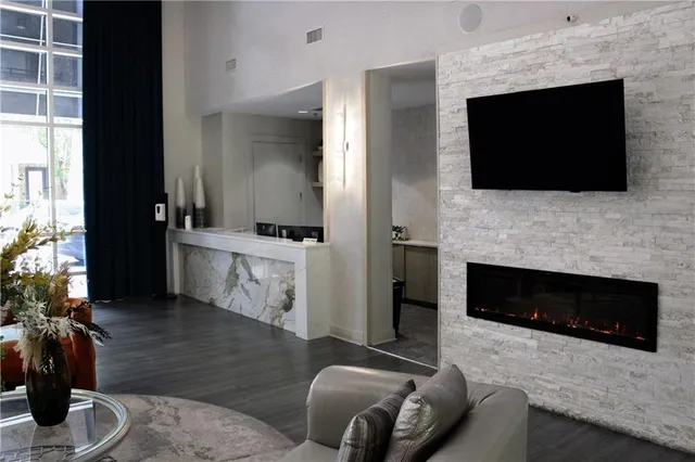 a living room with furniture a flat screen tv and a fireplace