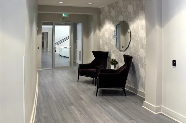 a living room with furniture and a mirror