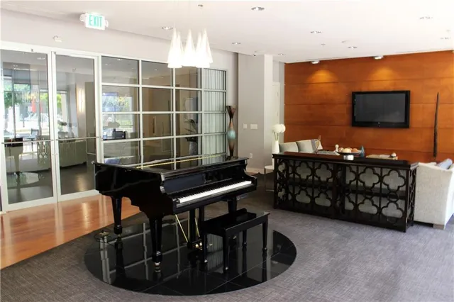 a living room with furniture a flat screen tv and outdoor view