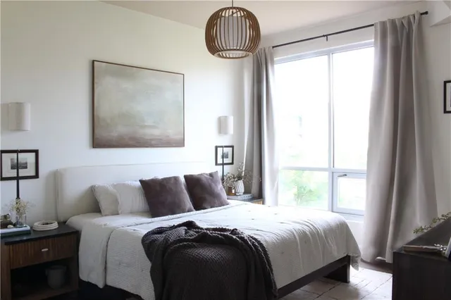 a bedroom with a bed and a window