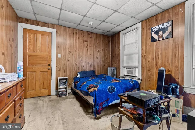 a bedroom with a bed and a desk