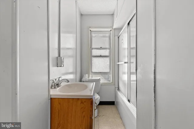 a bathroom with a sink a mirror and a bathtub