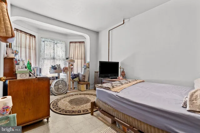 a bedroom with furniture a bed and a flat screen tv