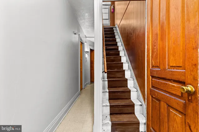a view of stairs and hall with wooden floor