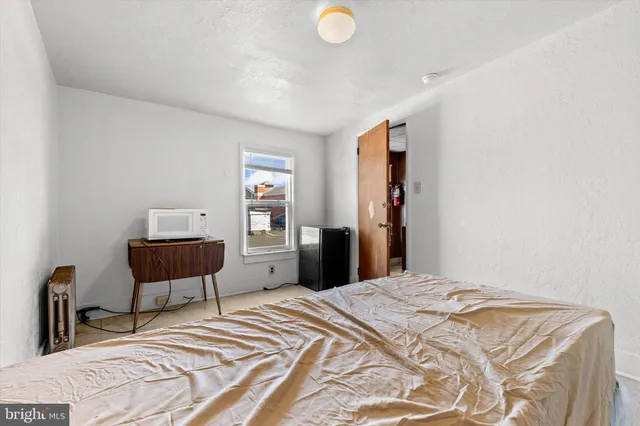 a bedroom with a bed and a chair