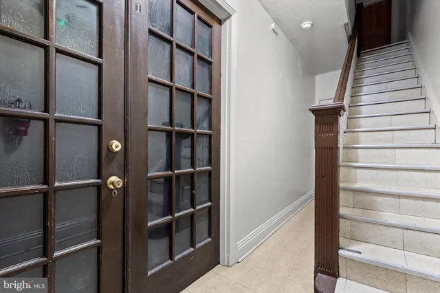 a view of staircase with white walls and window