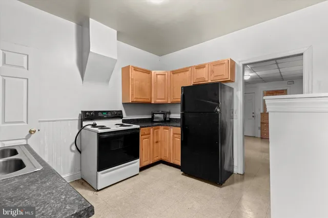 a kitchen with a refrigerator sink and stove