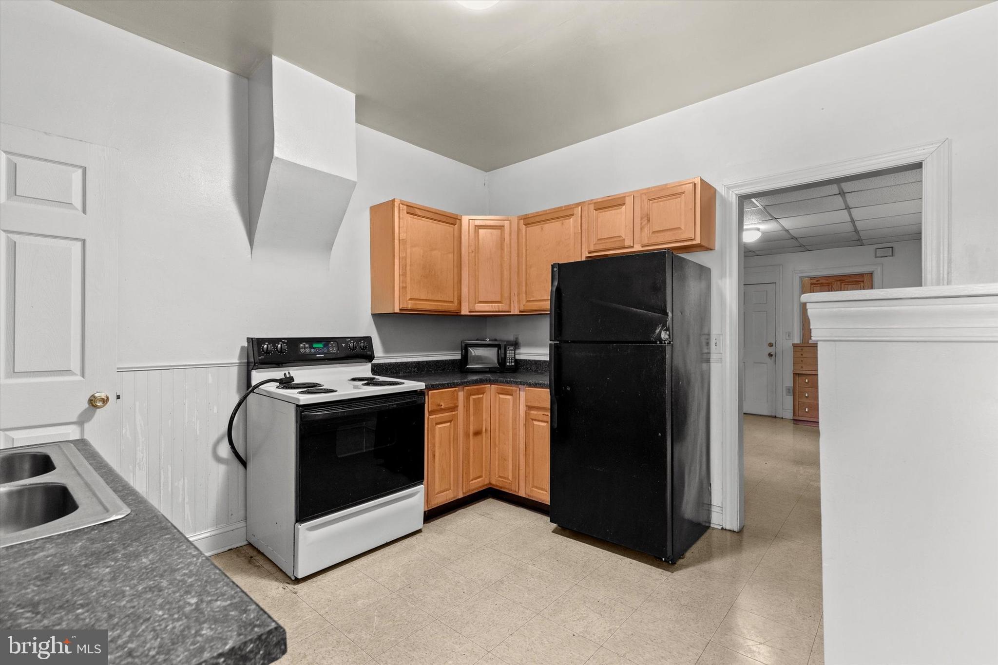 23 South West Street York, PA 17401 - Photo 10 of 39 a kitchen with a refrigerator sink and stove