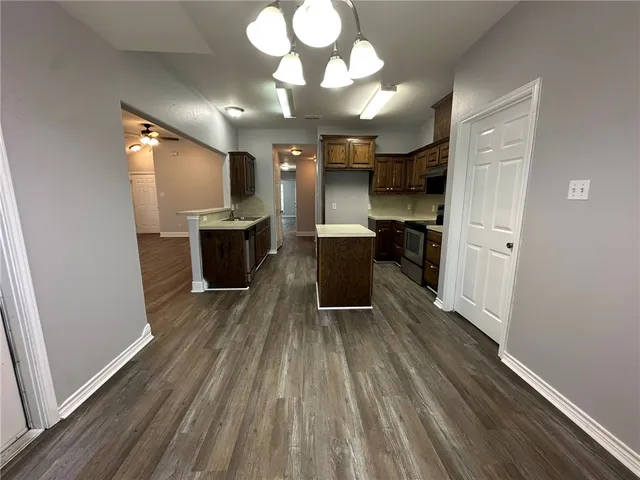 a kitchen with a sink and wooden floor