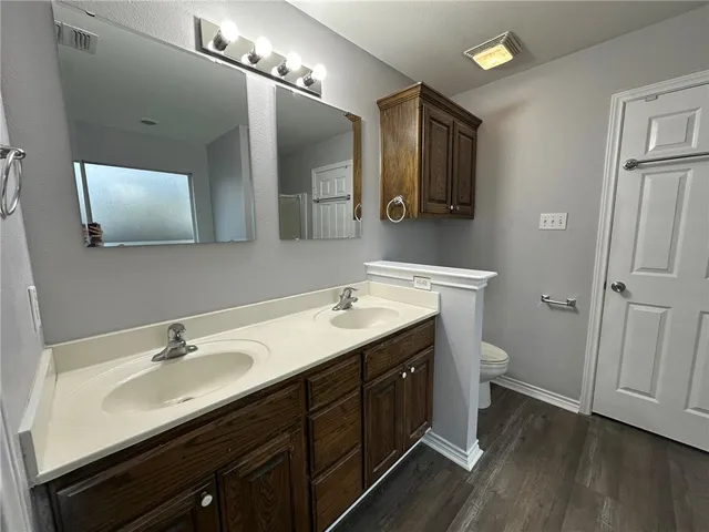 a bathroom with a double vanity sink and mirror