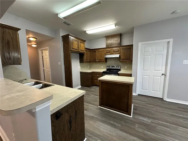 a kitchen with a sink a stove and a refrigerator