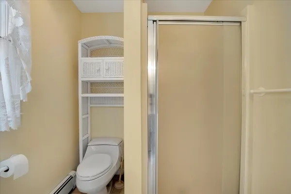 a bedroom with bed cabinet and a flat tv screen