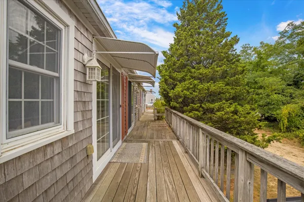 a view of balcony with wooden floor and fence