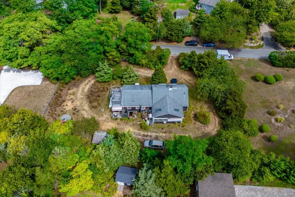 an aerial view of a house with a yard and garden