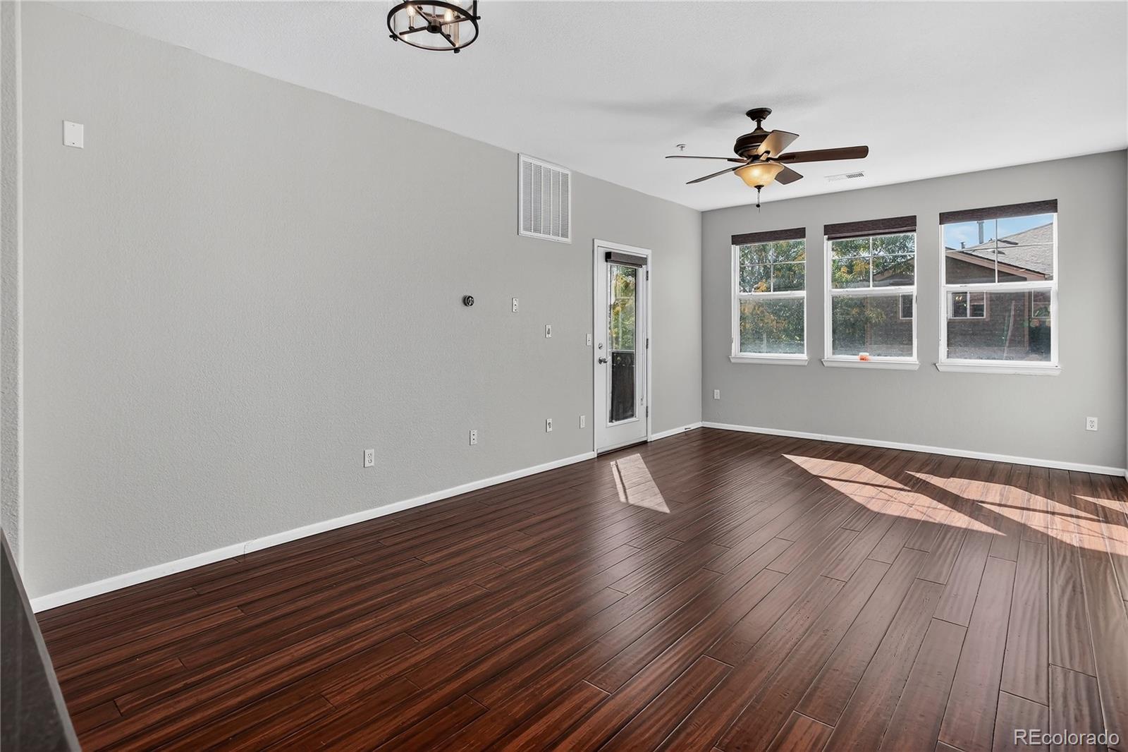 9633 East 5th Avenue, Unit 10208 Denver, CO 80230 - Photo 12 of 47 a view of an empty room with wooden floor and a window