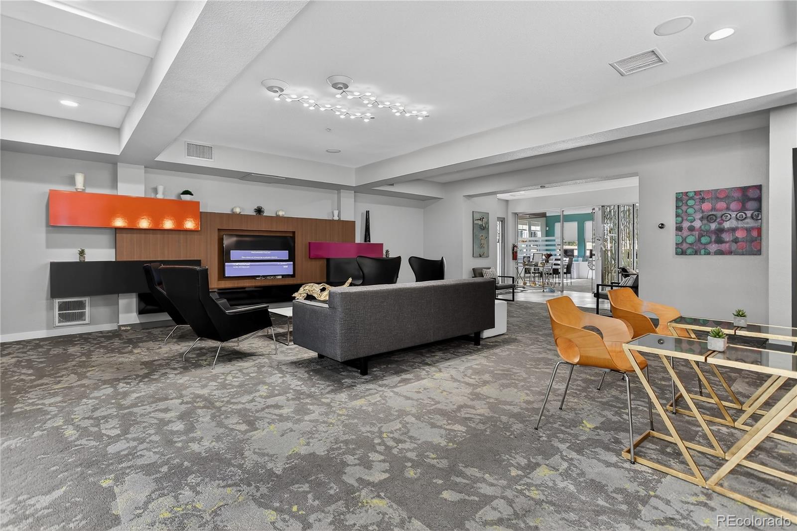 9633 East 5th Avenue, Unit 10208 Denver, CO 80230 - Photo 13 of 47 a living room with furniture a flat screen tv and a fireplace