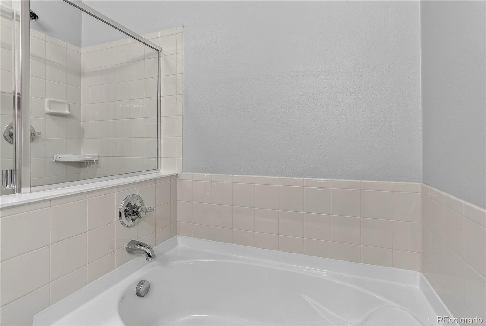 9633 East 5th Avenue, Unit 10208 Denver, CO 80230 - Photo 26 of 47 a bathroom with a bathtub
