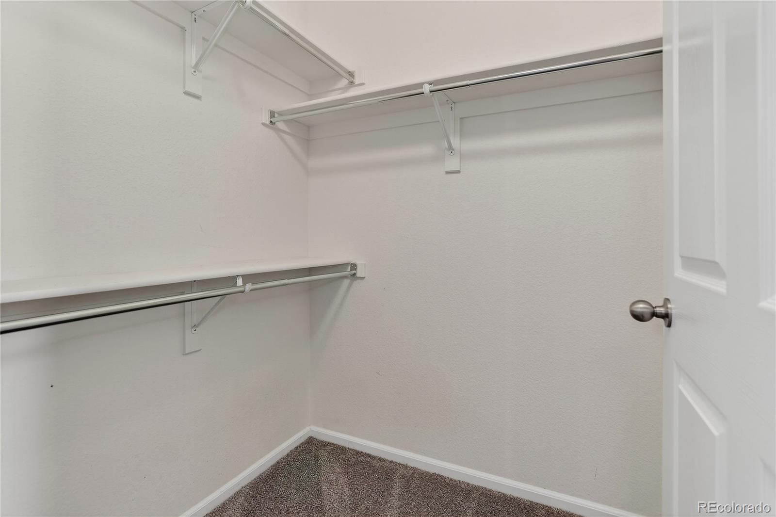 9633 East 5th Avenue, Unit 10208 Denver, CO 80230 - Photo 34 of 47 a view of a room with racks on the wall