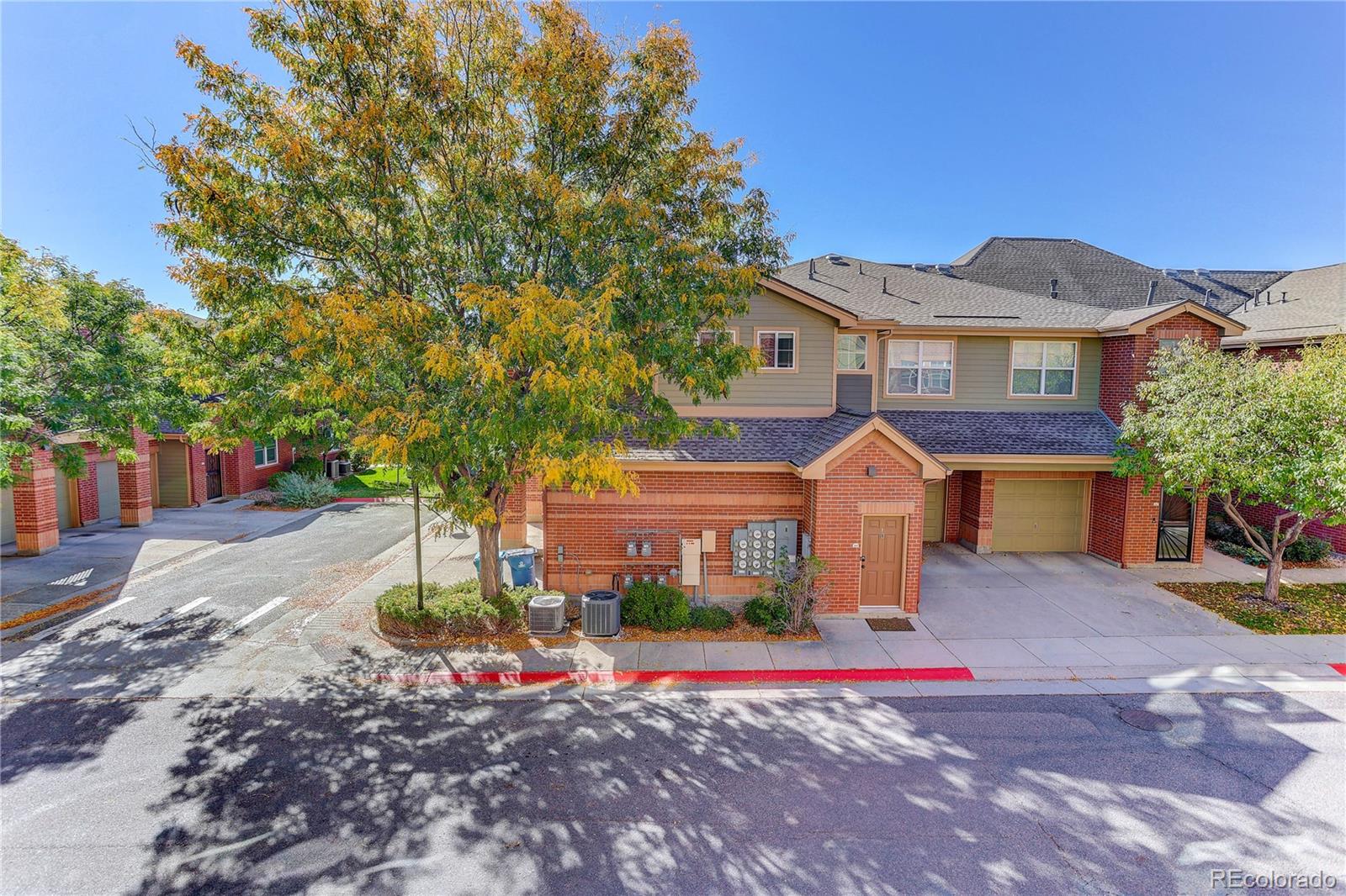 9633 East 5th Avenue, Unit 10208 Denver, CO 80230 - Photo 45 of 47 a front view of a house with a yard