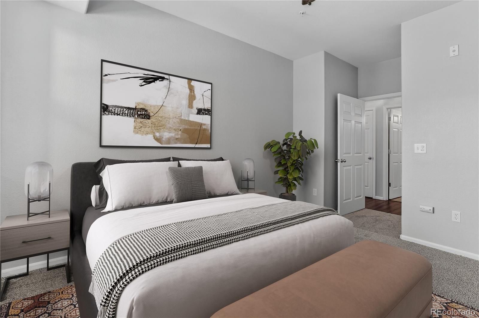 9633 East 5th Avenue, Unit 10208 Denver, CO 80230 - Photo 9 of 47 a bedroom with a bed and painting on the wall