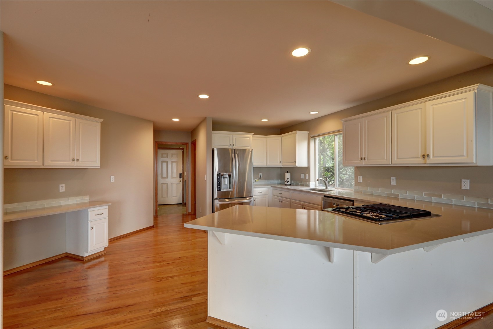 307 Southwest 295th Place Federal Way, WA 98023 - Photo 4 of 25 a kitchen with stainless steel appliances granite countertop a sink a stove a refrigerator and white cabinets with wooden floor