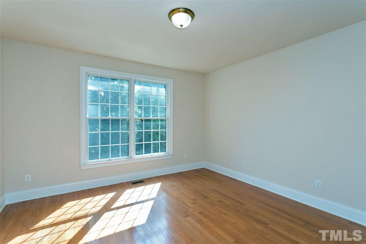 9505 Bluemont Court Raleigh, NC 27617 - Photo 15 of 25 an empty room with wooden floor and windows
