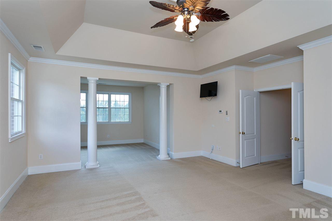 9505 Bluemont Court Raleigh, NC 27617 - Photo 17 of 25 an empty room with chandelier fan