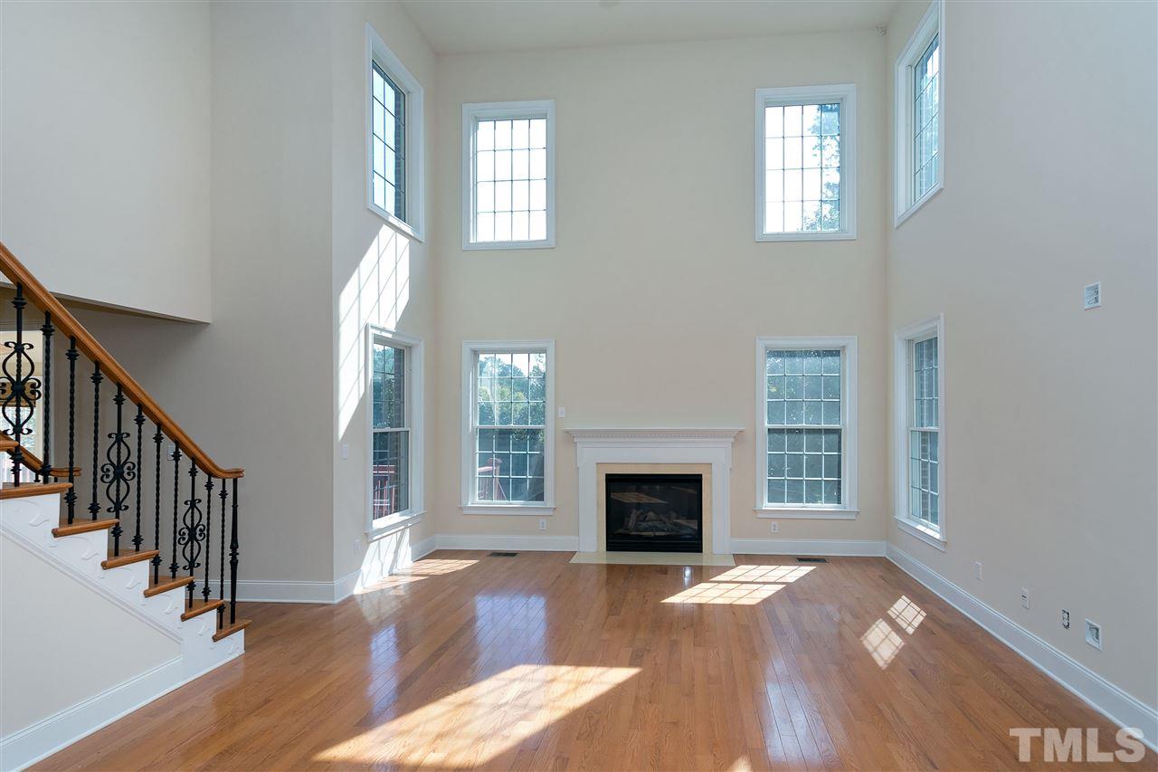 9505 Bluemont Court Raleigh, NC 27617 - Photo 6 of 25 a view of empty room with wooden floor and fireplace
