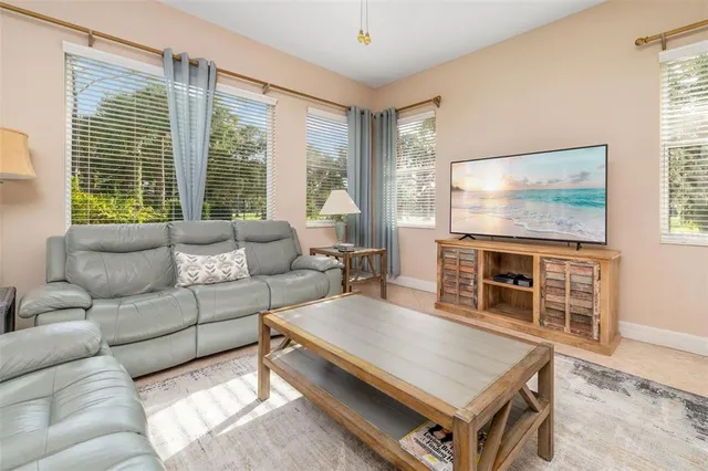 a living room with furniture and a large window