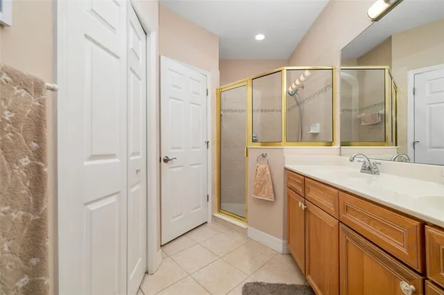 a en suite bathroom with a double vanity sink and a large mirror