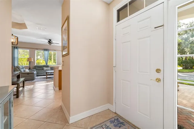 a view of a hallway with living room and dining room