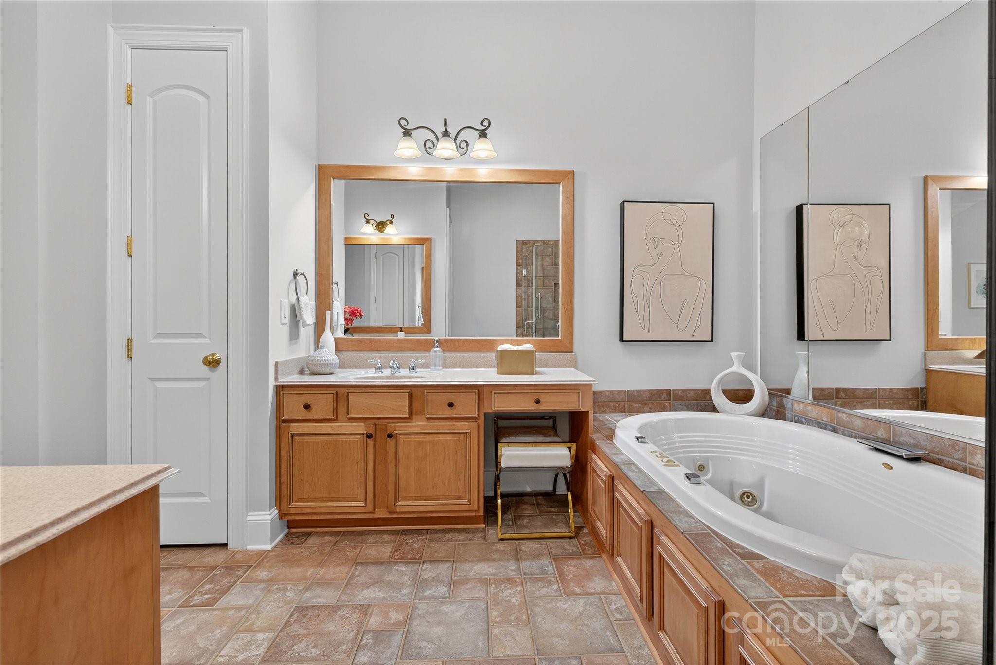 11756 Easthampton Circle Charlotte, NC 28277 - Photo 11 of 35 a bathroom with a tub sink and mirror