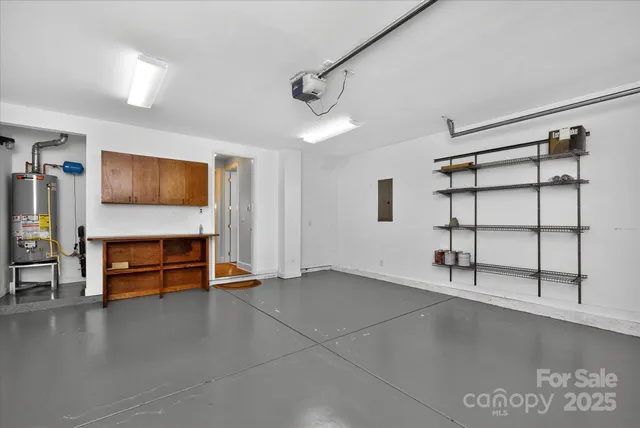 a view of an empty room with furniture and a window
