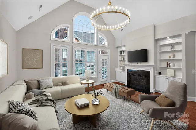 a living room with furniture a fireplace and a large window