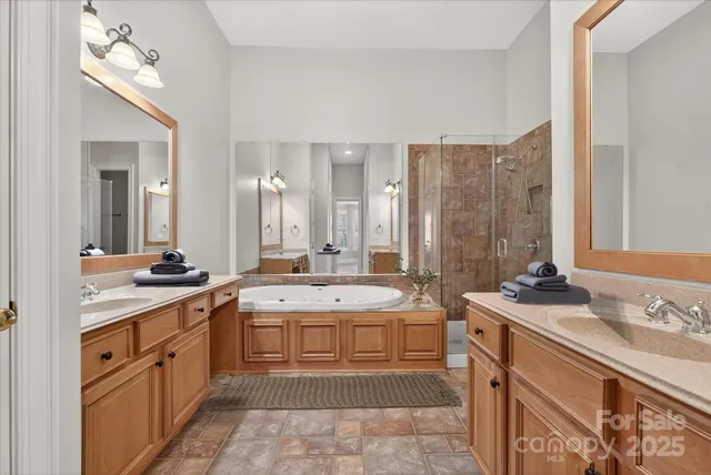 a spacious bathroom with a double vanity sink mirror and double