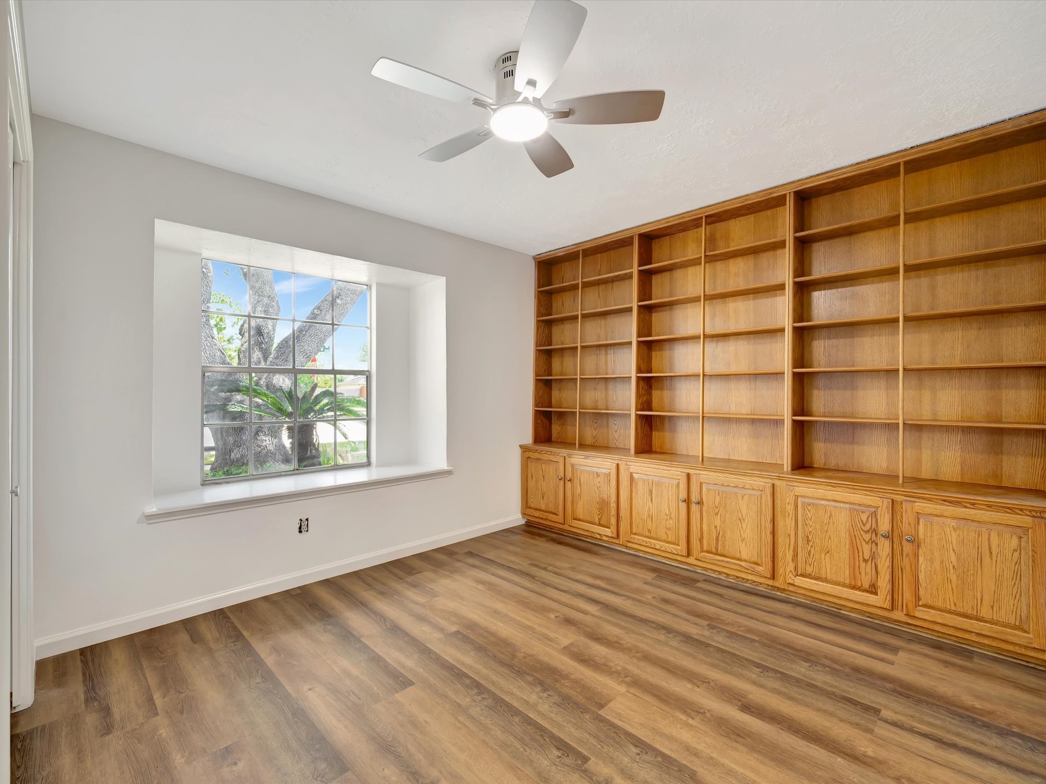 10340 Rocky Hollow Road La Porte, TX 77571 - Photo 21 of 38 The fourth bedroom features custom wood shelving, making it an ideal space for a home office or study.