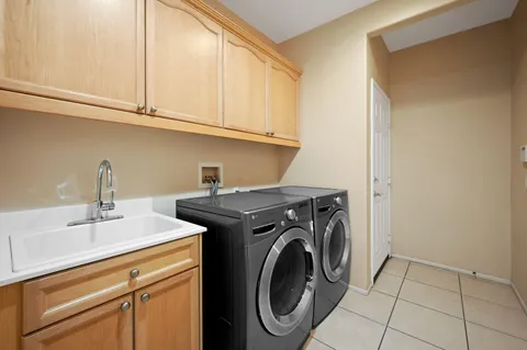 an empty room with windows and ceiling fan